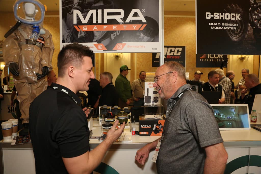 Two men talking at the SHOT Show