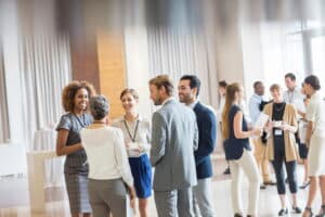 Individuals meeting and gathering at a conference.