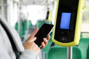 focus is on a person using their cellphone to order mobile tickets