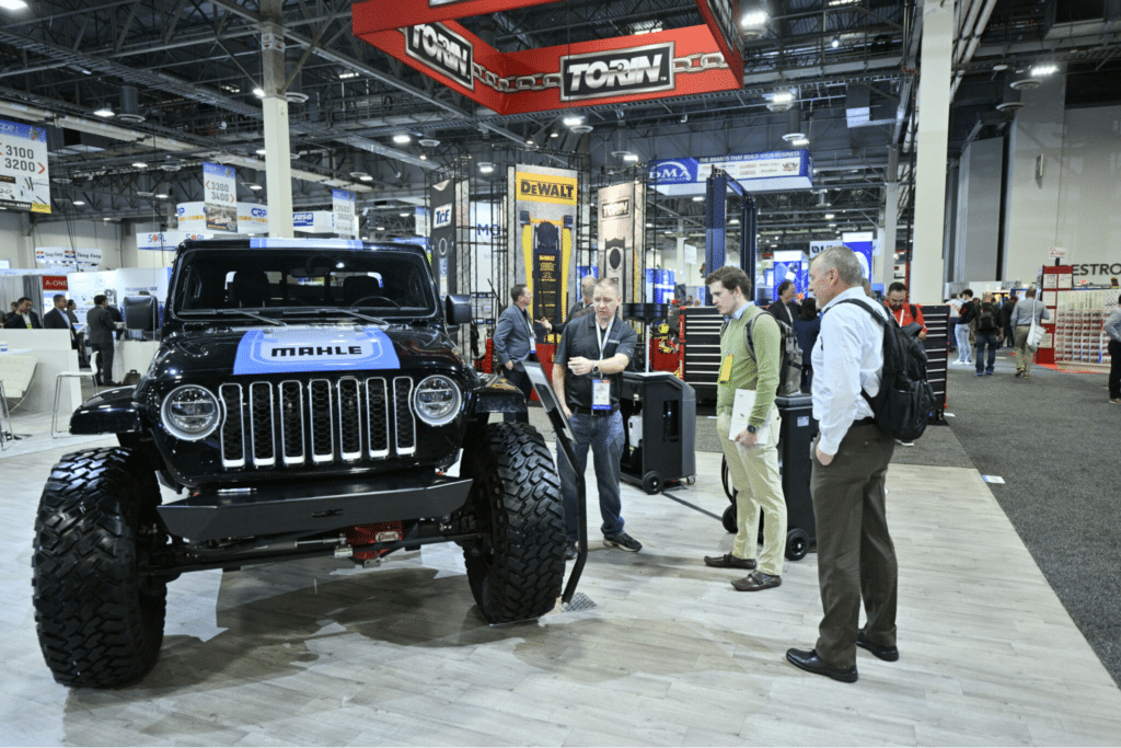 Attendees Looking At A Vehicle From A Previous Automotive Aftermarket Products Expo.