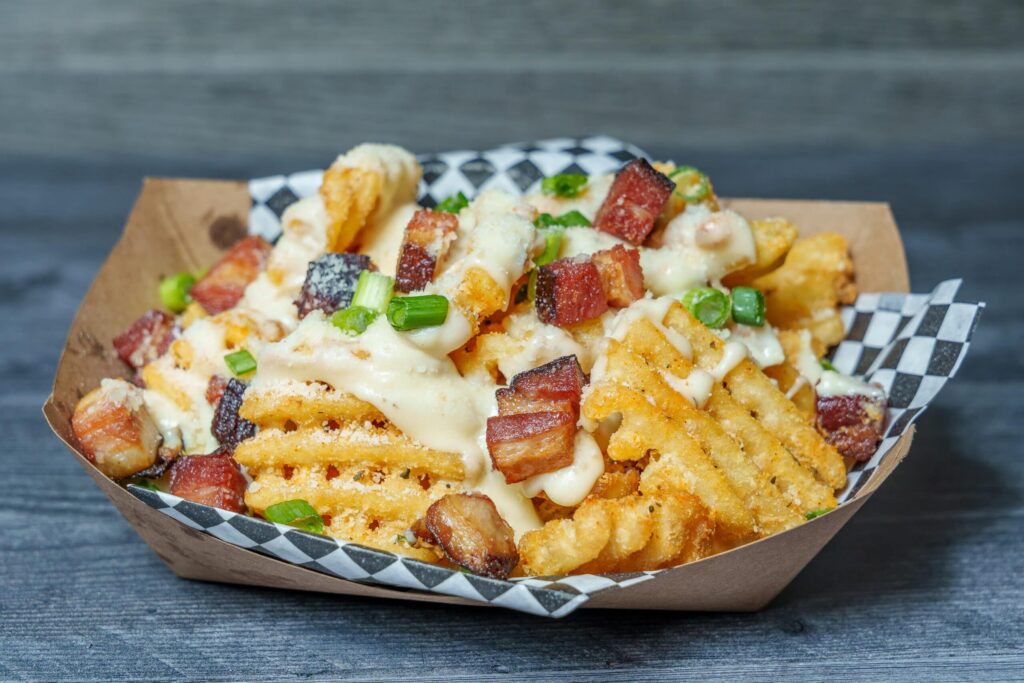 Buddys Jerseys Eats Fries with cheese and bacon 