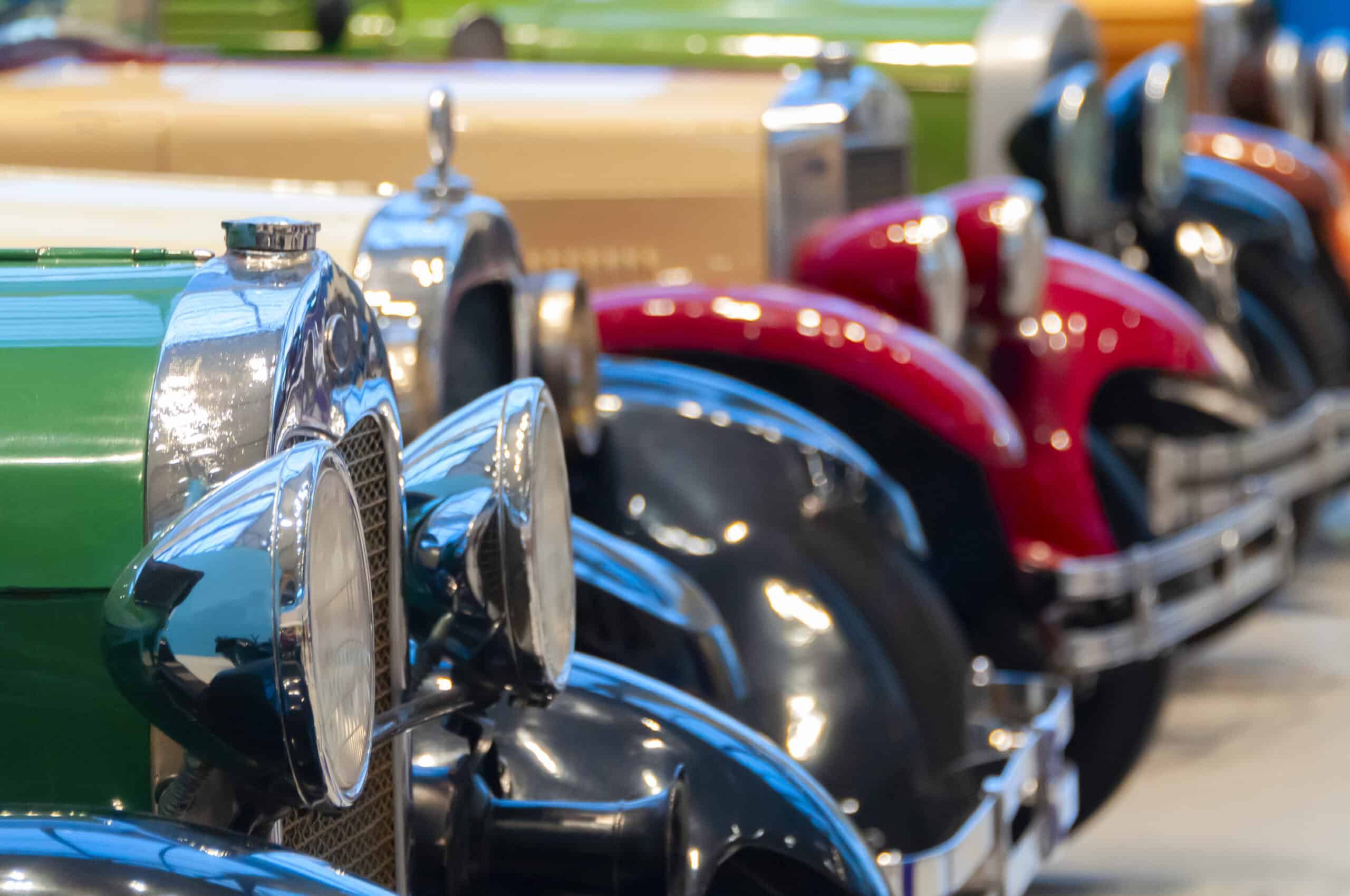 vintage cars standing in a row front with headlights