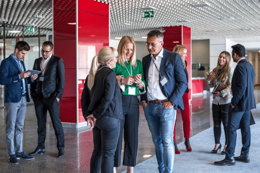 Coverings Trade Show 2026 1 Attendees Speaking Together At A Trade Show.