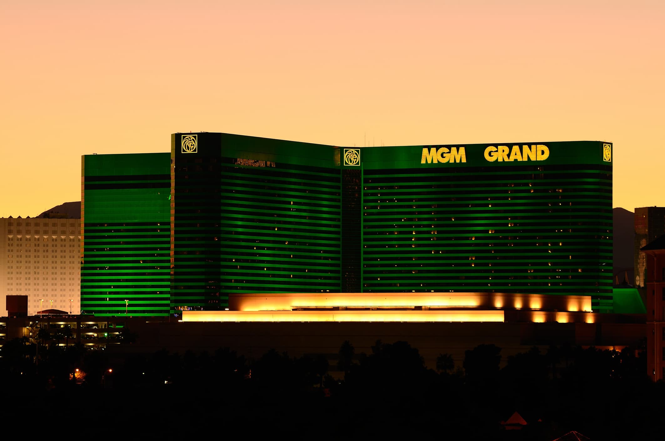 Sunset view of the iconic MGM Grand Las Vegas hotel, showcasing its striking green exterior and glowing lights, a centerpiece for exploring the top things to do at the MGM.