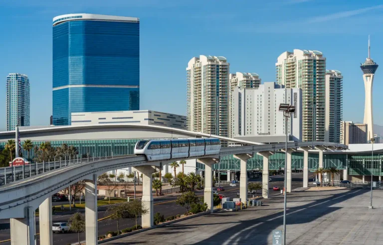 Las Vegas Monorail train traveling on the elevated track with the Las Vegas Strip skyline and The STRAT tower in the background