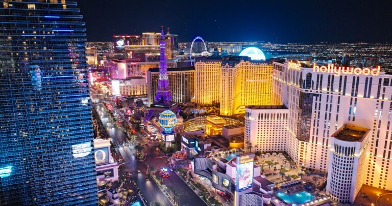 Aerial view of the Las Vegas Strip at night featuring illuminated resorts and casinos.